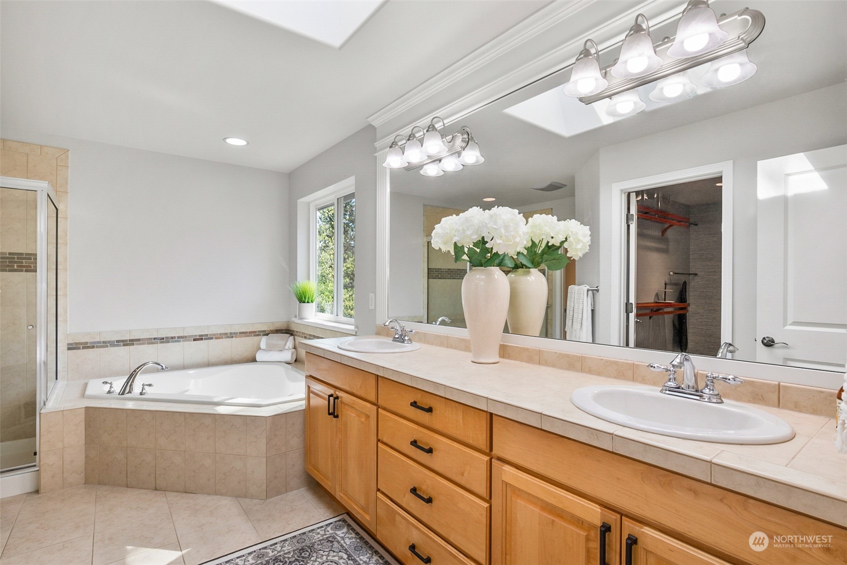 2732 233rd Place Southeast Bothell, WA 98021 - Photo 28 of 40 a bathroom with a granite countertop double vanity sink and a bathtub