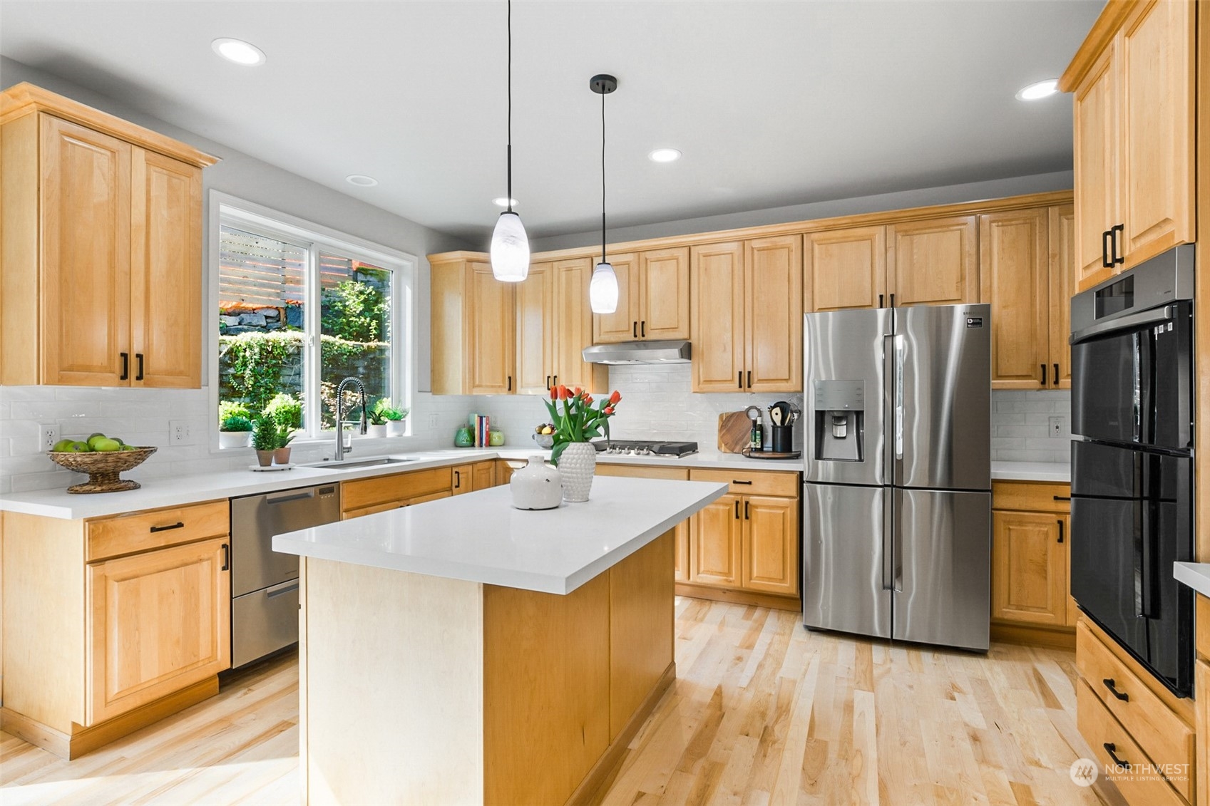 2732 233rd Place Southeast Bothell, WA 98021 - Photo 5 of 40 a kitchen with a sink a counter top space stainless steel appliances and windows