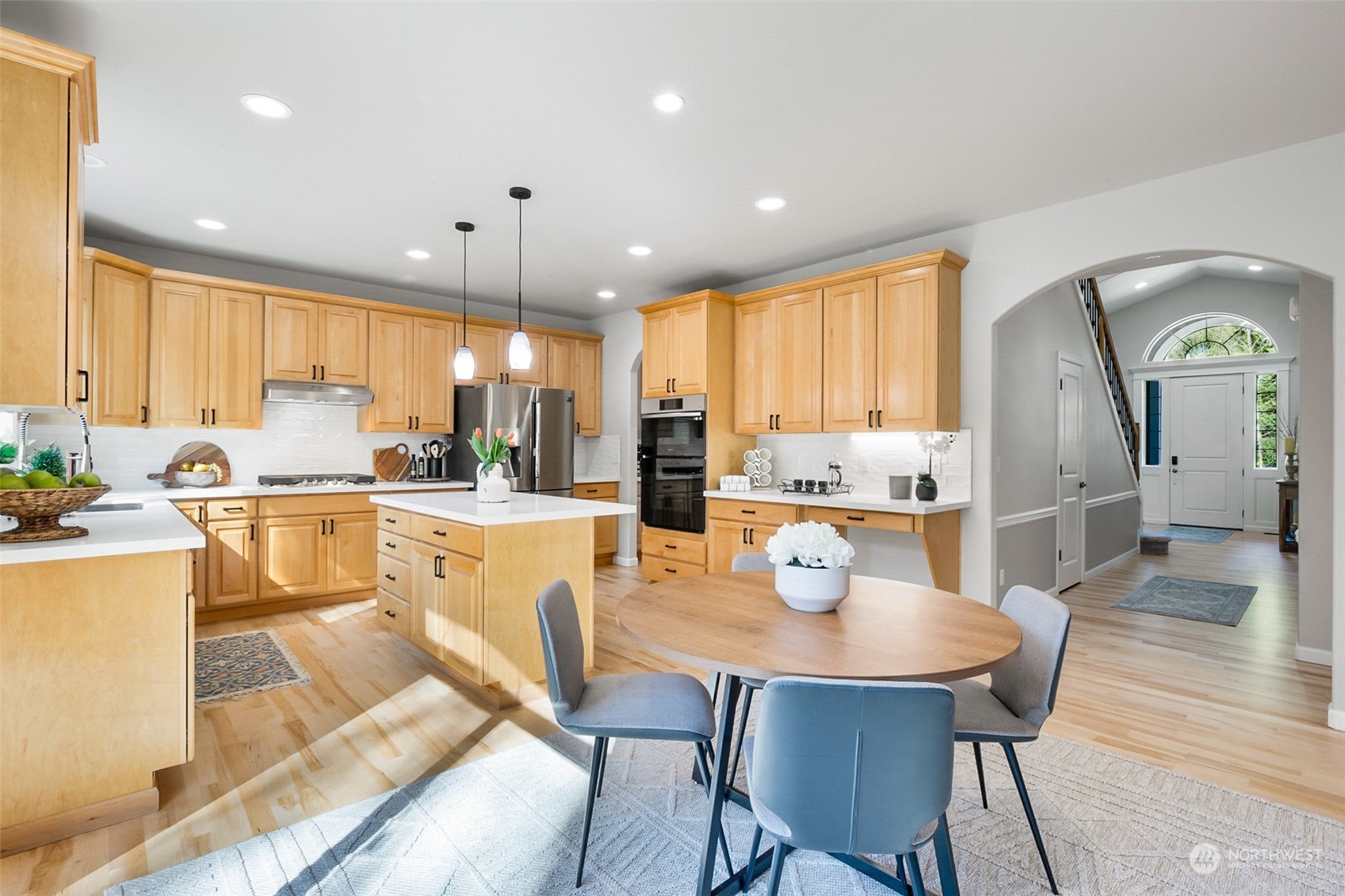 2732 233rd Place Southeast Bothell, WA 98021 - Photo 7 of 40 a kitchen with stainless steel appliances granite countertop a stove a sink a refrigerator white cabinets and couches with wooden floor