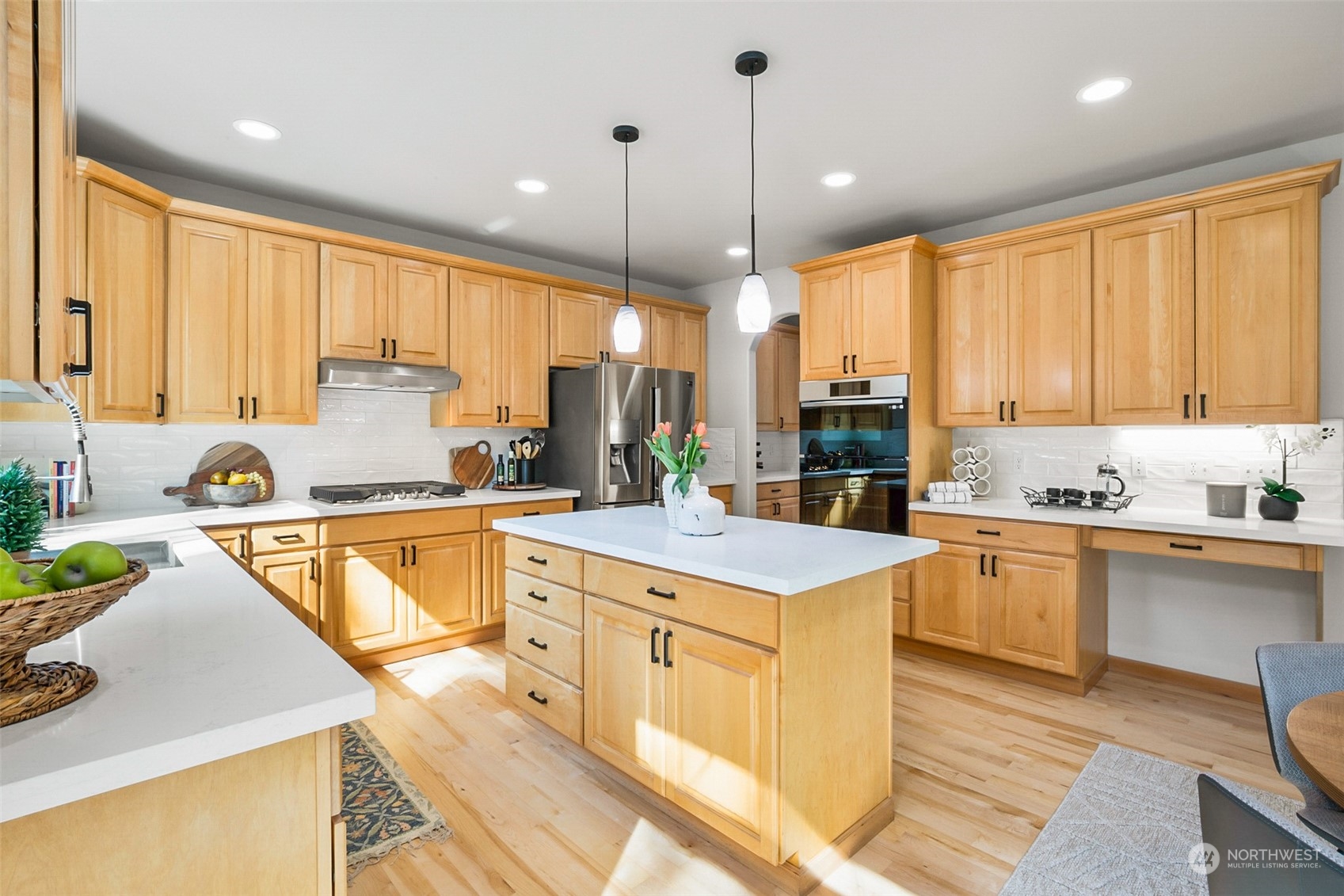 2732 233rd Place Southeast Bothell, WA 98021 - Photo 10 of 40 a large kitchen with kitchen island granite countertop a stove a sink a center island and cabinets