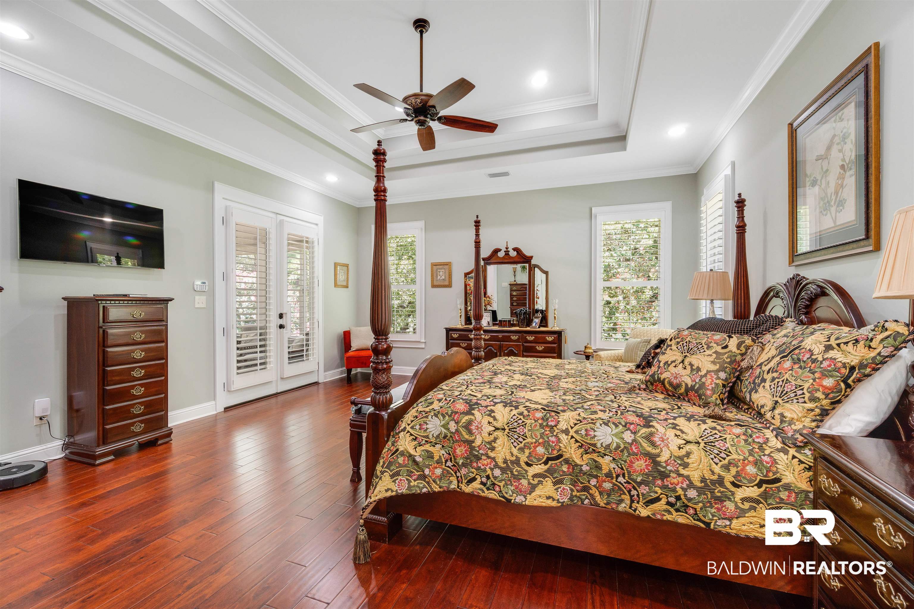 11281 Redfern Road Daphne, AL 36526 - Photo 27 of 80 Bedroom featuring a raised ceiling, dark hardwood / wood-style floors, access to exterior, ornamental molding, and ceiling fan
