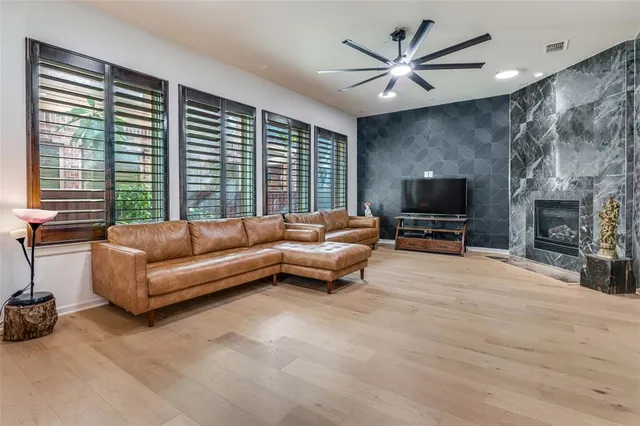 a living room with furniture a flat screen tv and a fireplace