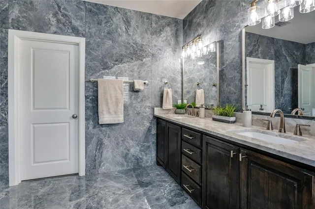a bathroom with a double vanity sink and a mirror