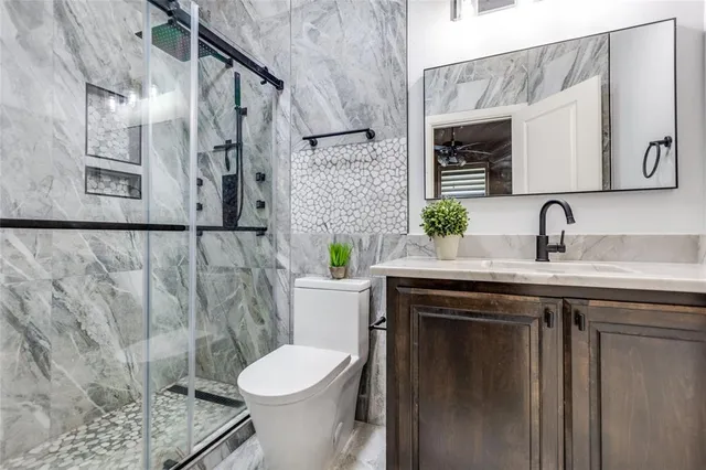 a bathroom with a sink toilet and shower