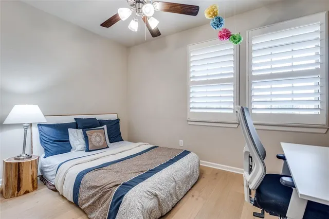 a bedroom with a large bed and a chandelier