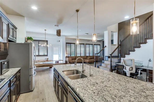 a kitchen with sink stove and cabinets