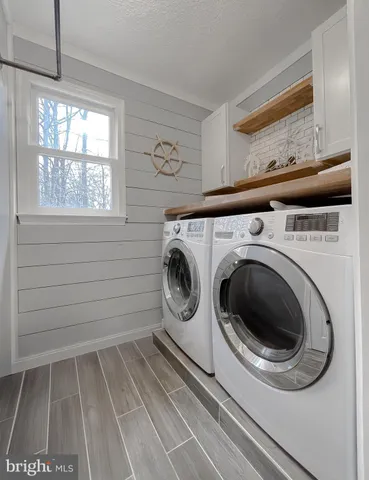 a bathroom with a double vanity sink toilet and a mirror