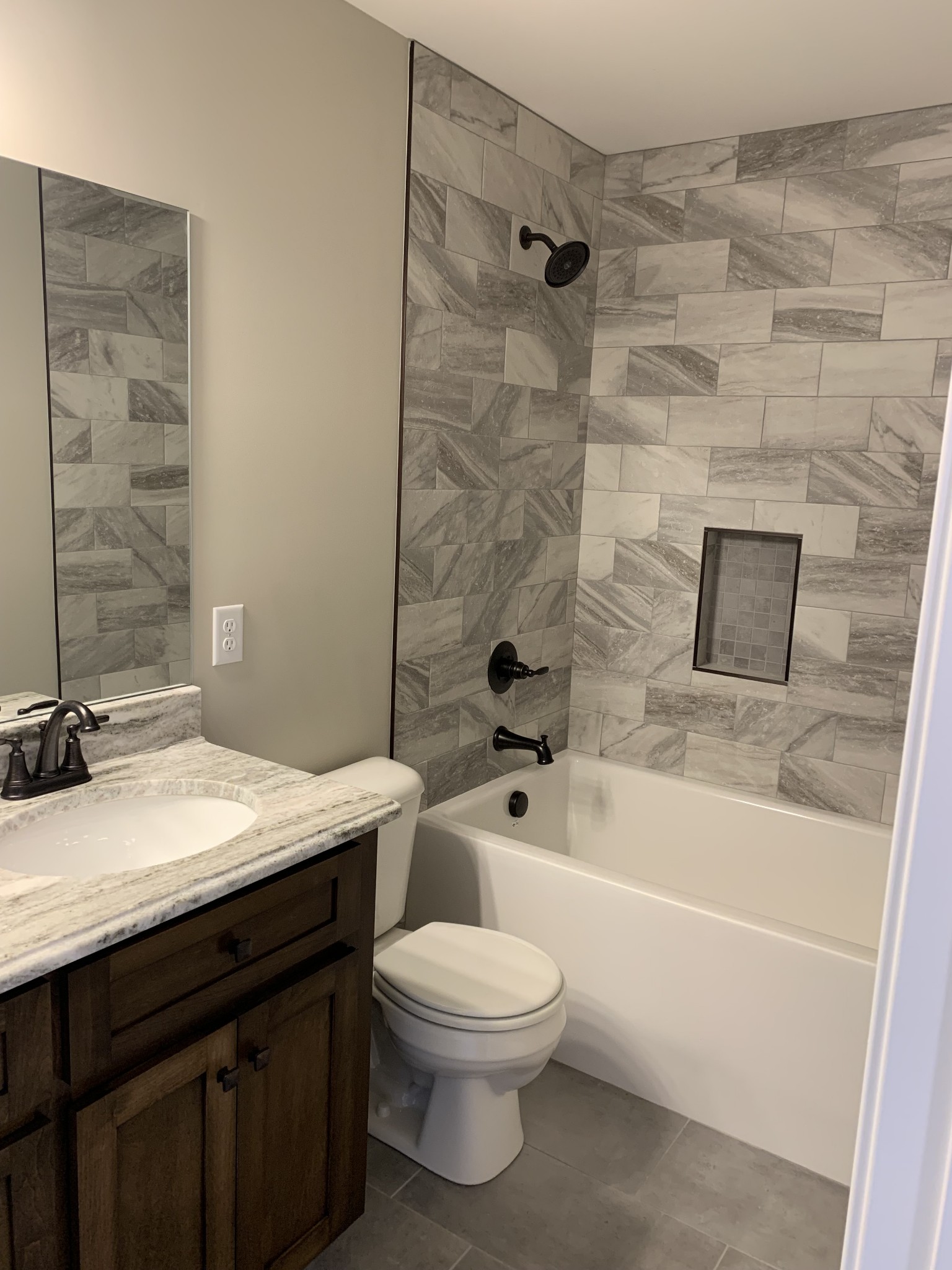 589 Womack Road Bethpage, TN 37022 - Photo 13 of 20 a bathroom with a granite countertop bathtub shower sink mirror and toilet