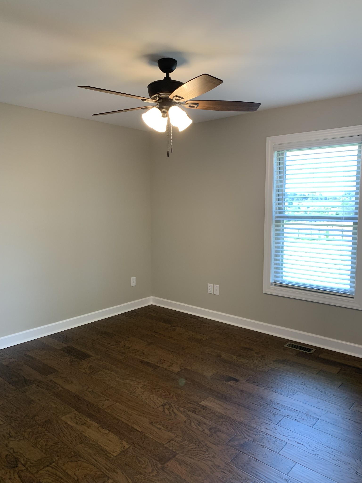 589 Womack Road Bethpage, TN 37022 - Photo 16 of 20 a view of an empty room with wooden floor and a window