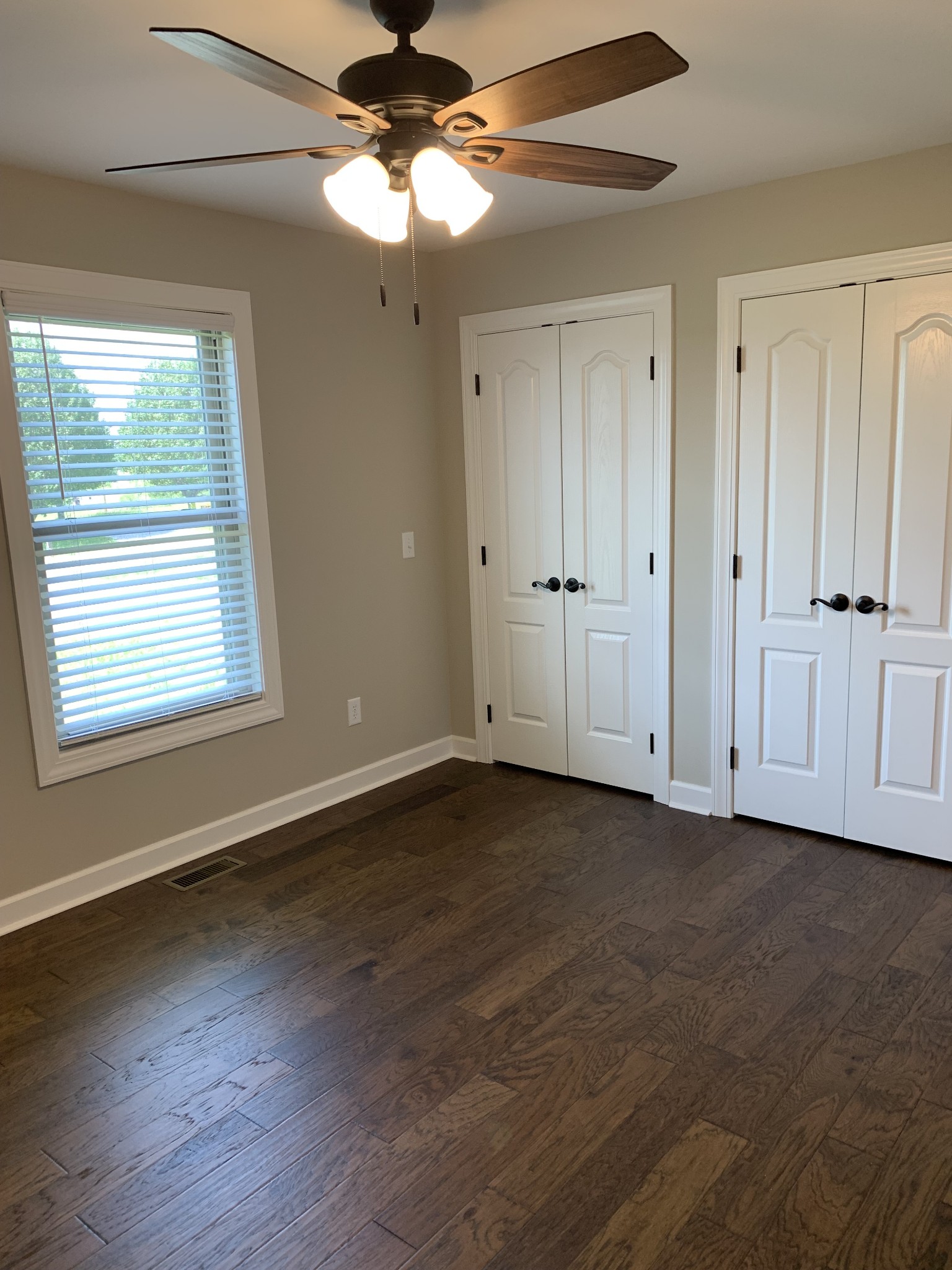 589 Womack Road Bethpage, TN 37022 - Photo 17 of 20 a view of an empty room with wooden floor and a window
