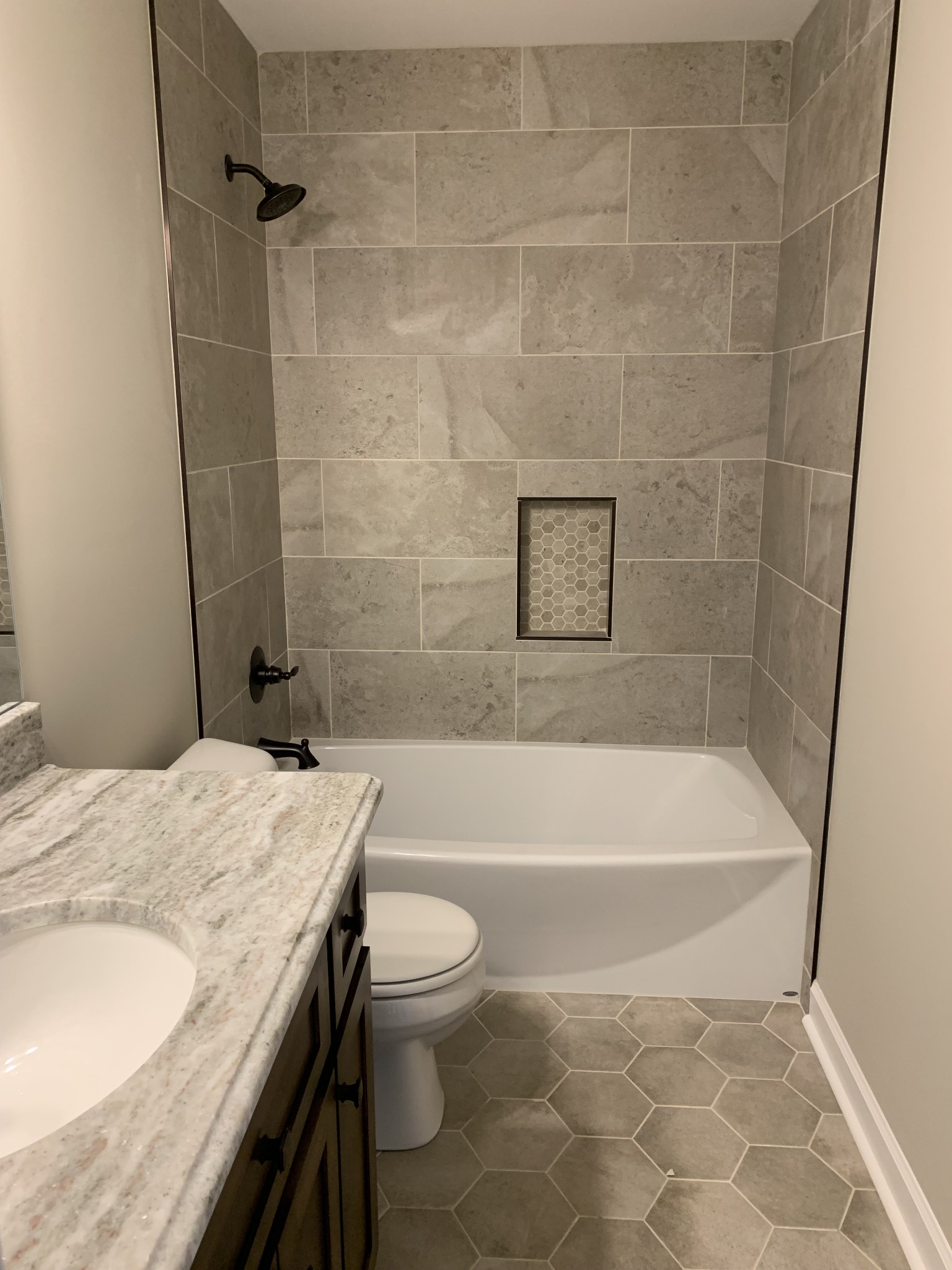 589 Womack Road Bethpage, TN 37022 - Photo 18 of 20 a bathroom with a granite countertop bathtub shower sink vanity and toilet
