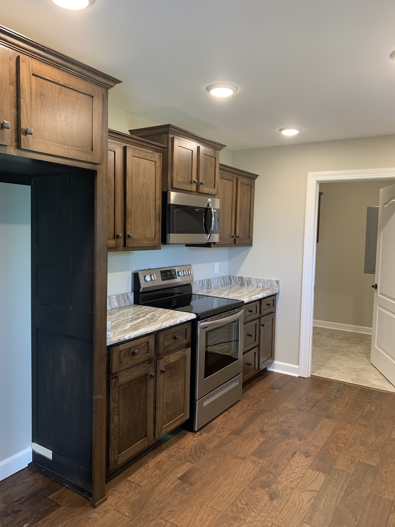 589 Womack Road Bethpage, TN 37022 - Photo 4 of 20 a kitchen with stainless steel appliances granite countertop a refrigerator a stove top oven a sink and dishwasher