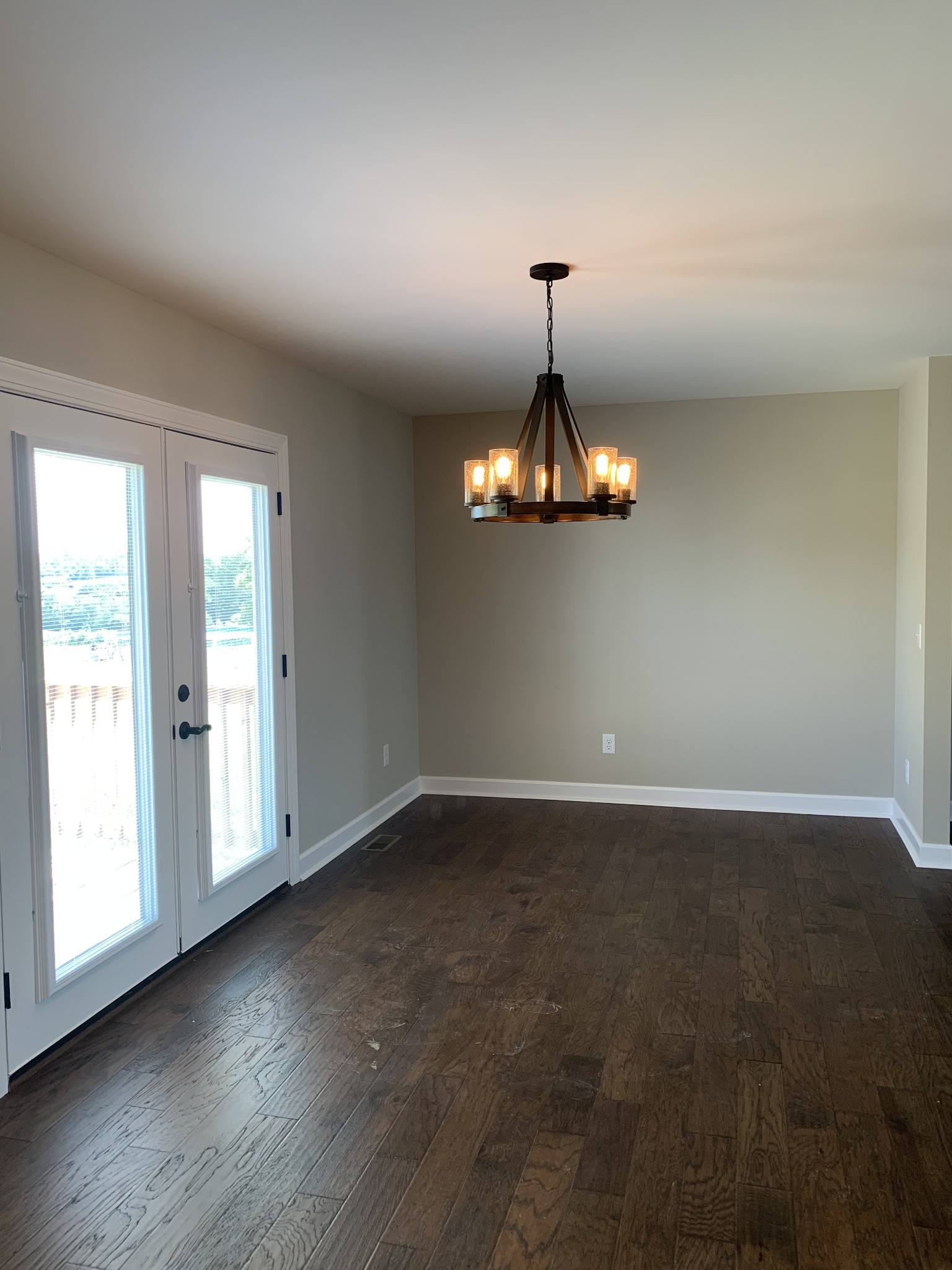 589 Womack Road Bethpage, TN 37022 - Photo 7 of 20 an empty room with wooden floor and chandelier