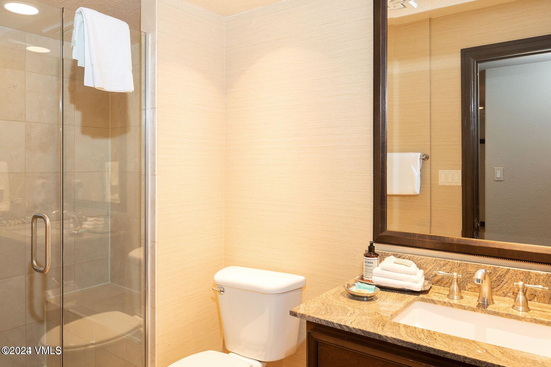 210 Offerson Road, Unit 212WEEK 51 Beaver Creek, CO 81620 - Photo 11 of 24 a bathroom with a granite countertop sink and a mirror