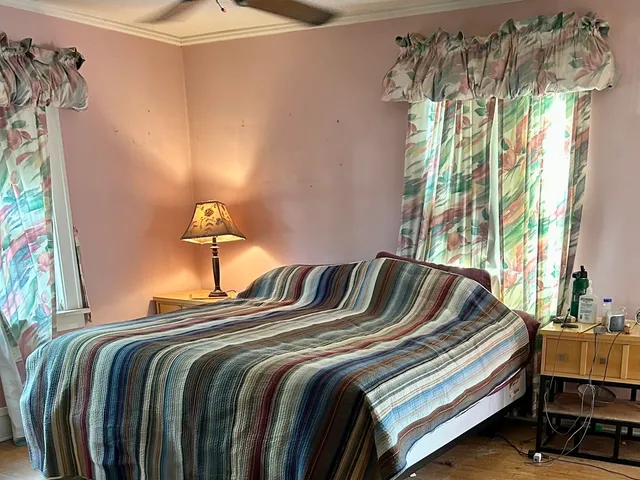 a bedroom with a bed and a window