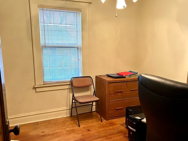 a room with a chair and a dresser