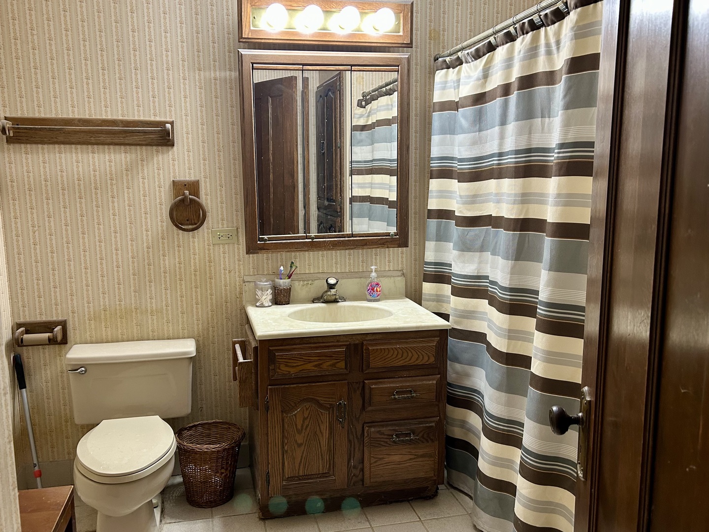 8542 School Street Morton Grove, IL 60053 - Photo 20 of 28 a bathroom with a sink a toilet a mirror and shower