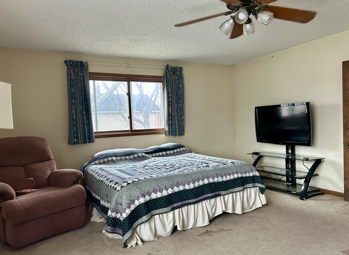 8542 School Street Morton Grove, IL 60053 - Photo 10 of 28 a bedroom with a bed couch and a flat screen tv