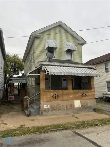 a front view of a house with yard