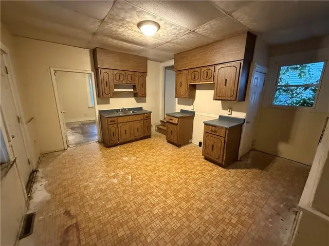 a large room with stainless steel appliances wooden floors and living room view