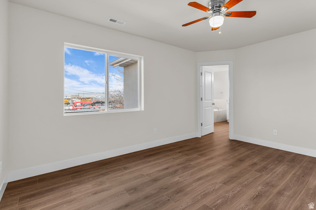 578 West 7th Midvale, UT 84047 - Photo 13 of 35 Spare room featuring dark wood-type flooring and a ceiling fan