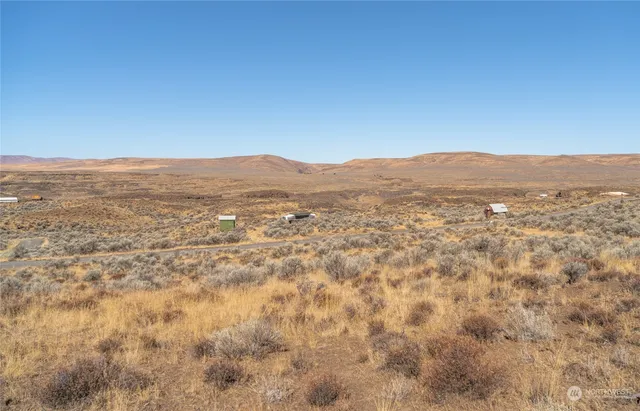 a blue sign that is sitting in front of a house