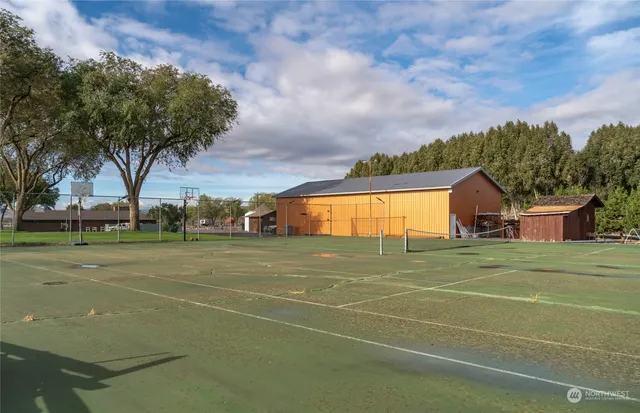 an aerial view of houses with yard and mountain view in back