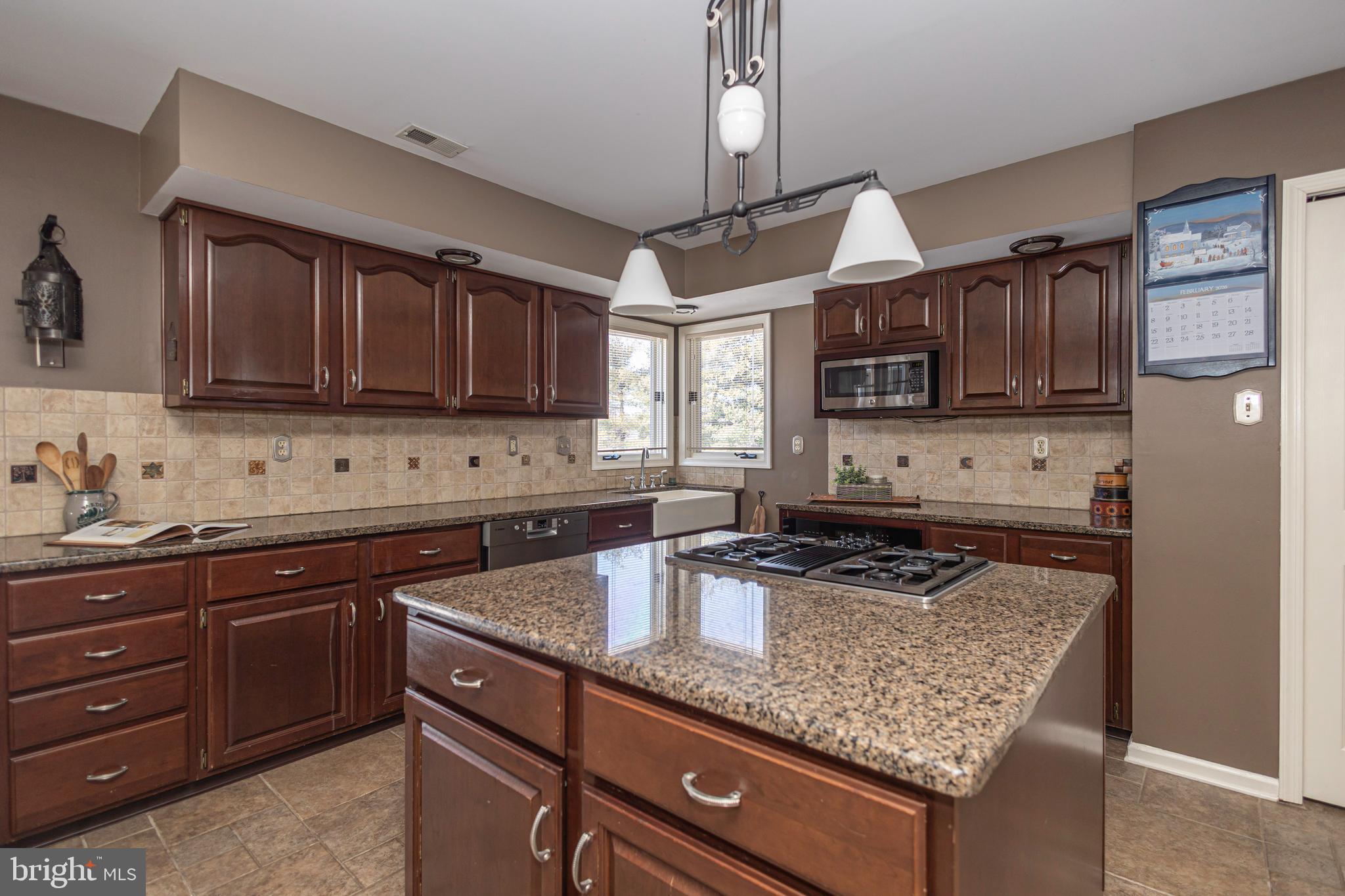 895 Slate Hill Road Yardley, PA 19067 - Photo 22 of 67 a kitchen with stainless steel appliances granite countertop a sink stove and microwave