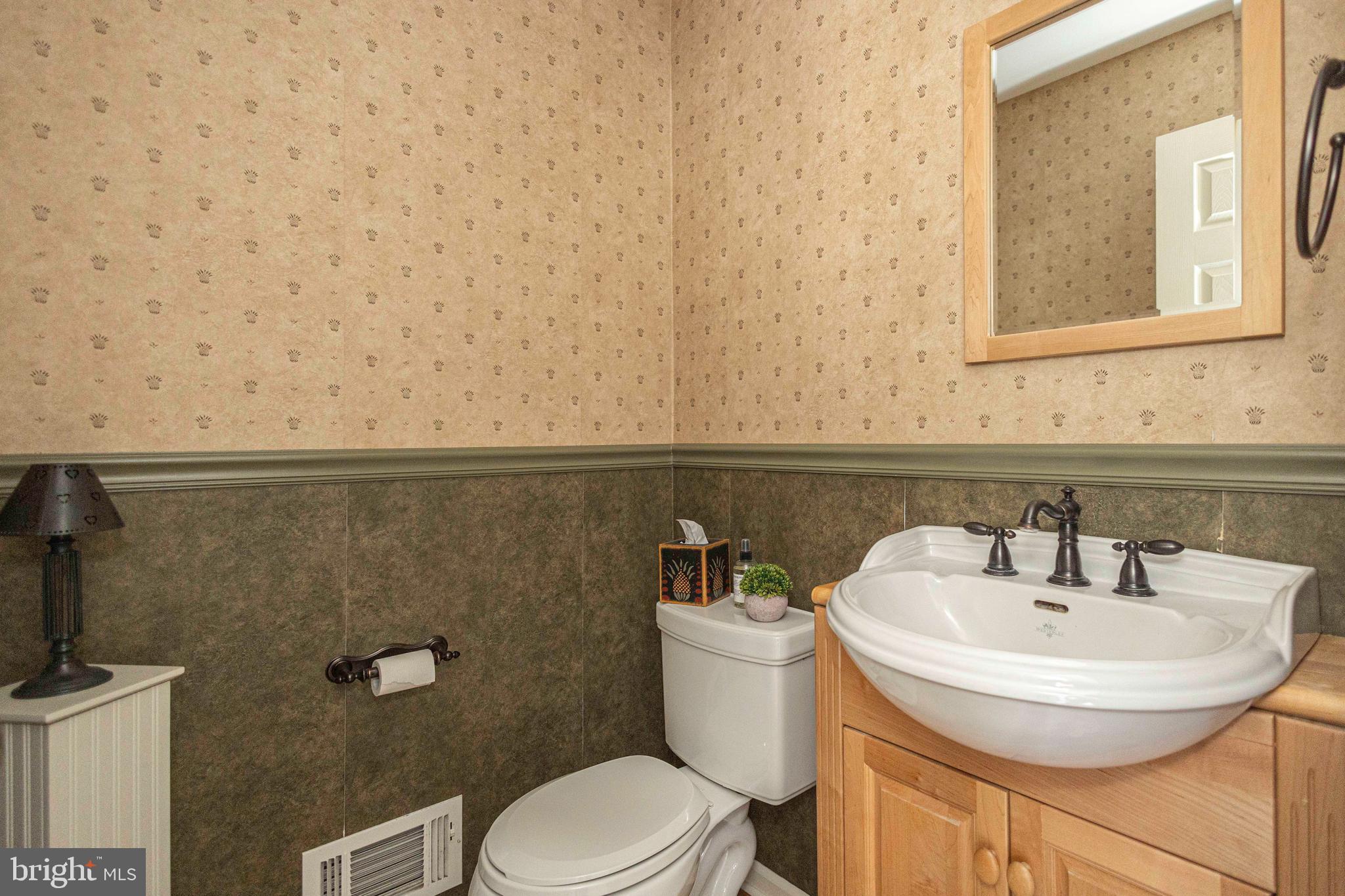 895 Slate Hill Road Yardley, PA 19067 - Photo 42 of 67 a bathroom with a sink a toilet and a mirror