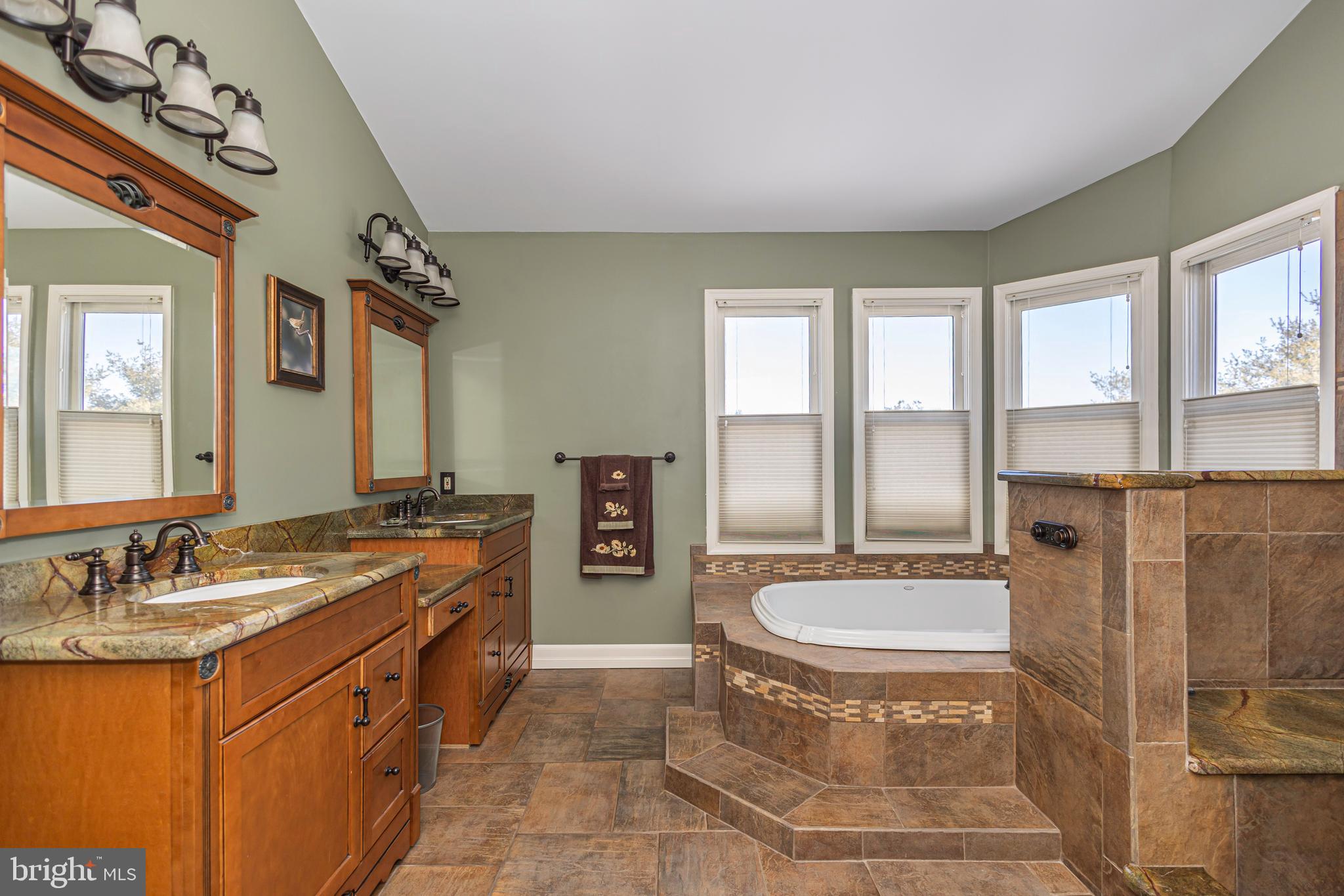 895 Slate Hill Road Yardley, PA 19067 - Photo 51 of 67 a spacious bathroom with a tub sink and mirror