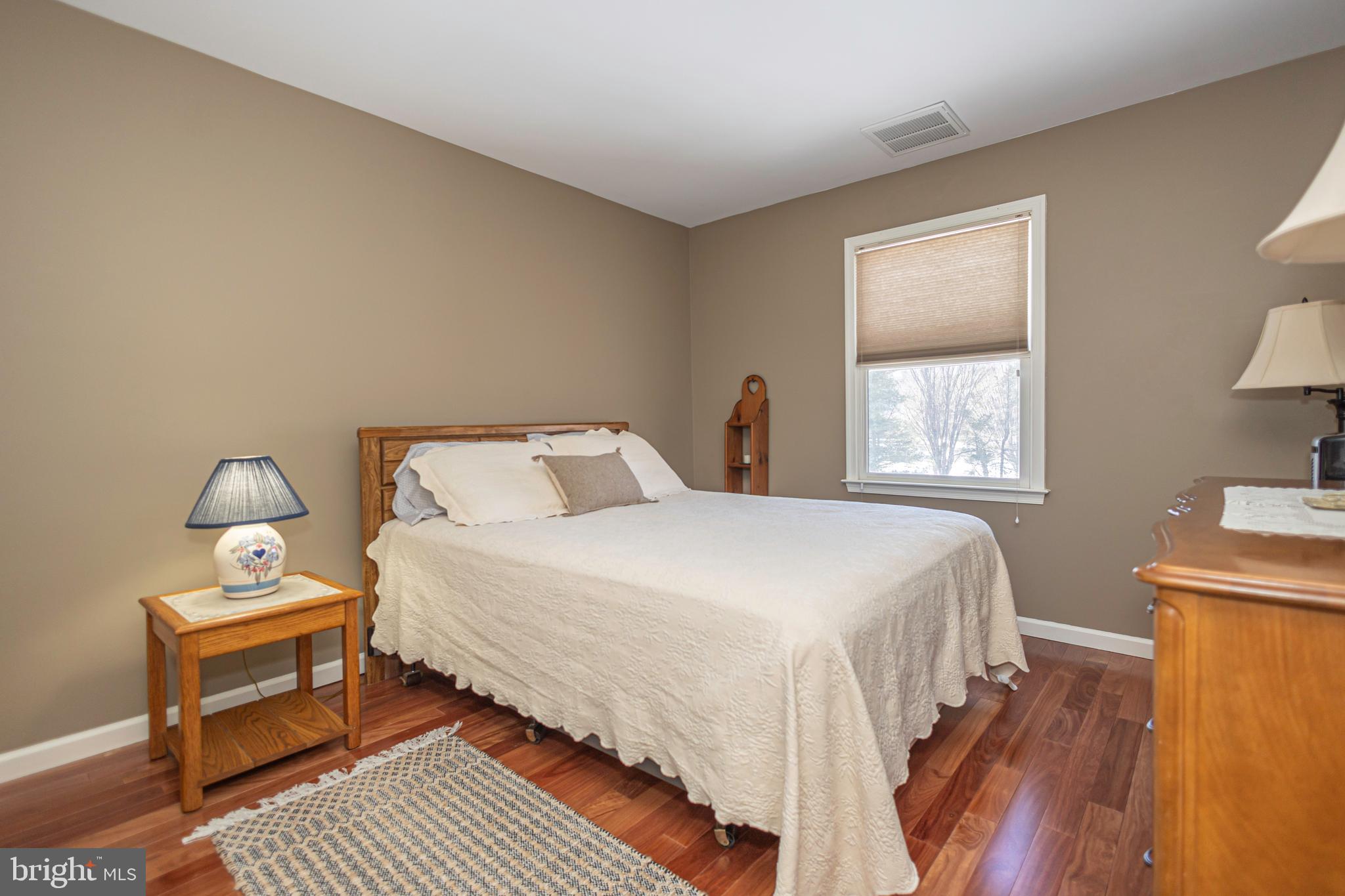 895 Slate Hill Road Yardley, PA 19067 - Photo 57 of 67 a bedroom with a bed and wooden floor