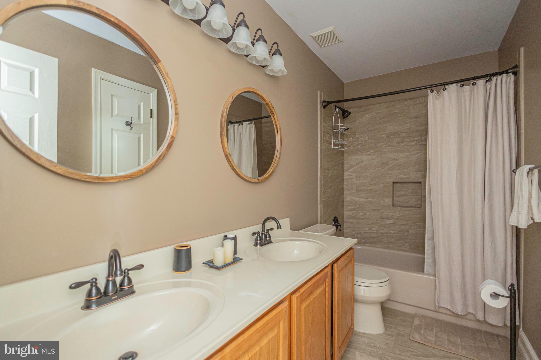 895 Slate Hill Road Yardley, PA 19067 - Photo 60 of 67 a bathroom with a double vanity sink mirror and toilet