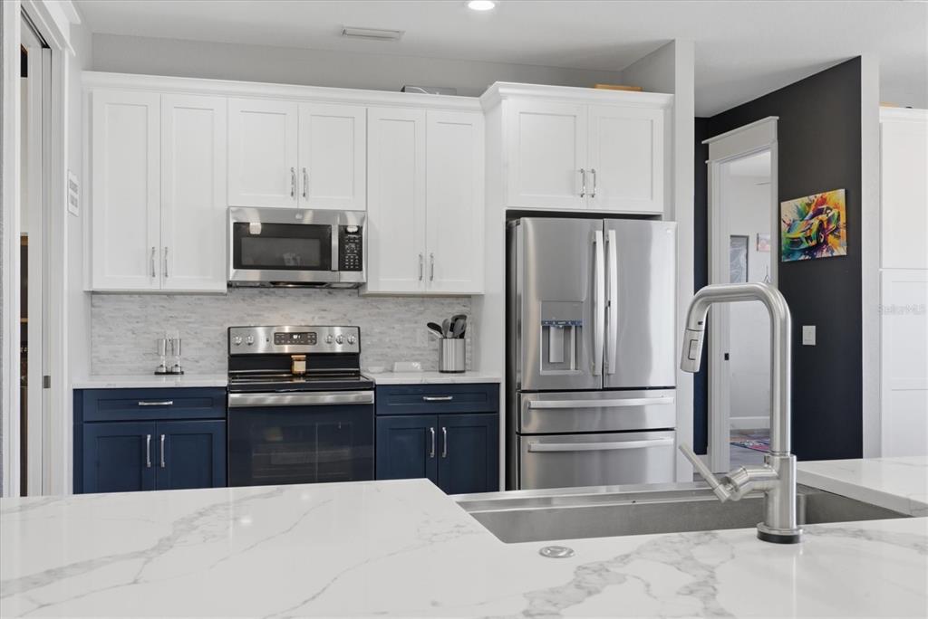 20 Brig Circle East Placida, FL 33946 - Photo 11 of 44 a kitchen with stainless steel appliances a refrigerator sink and white cabinets
