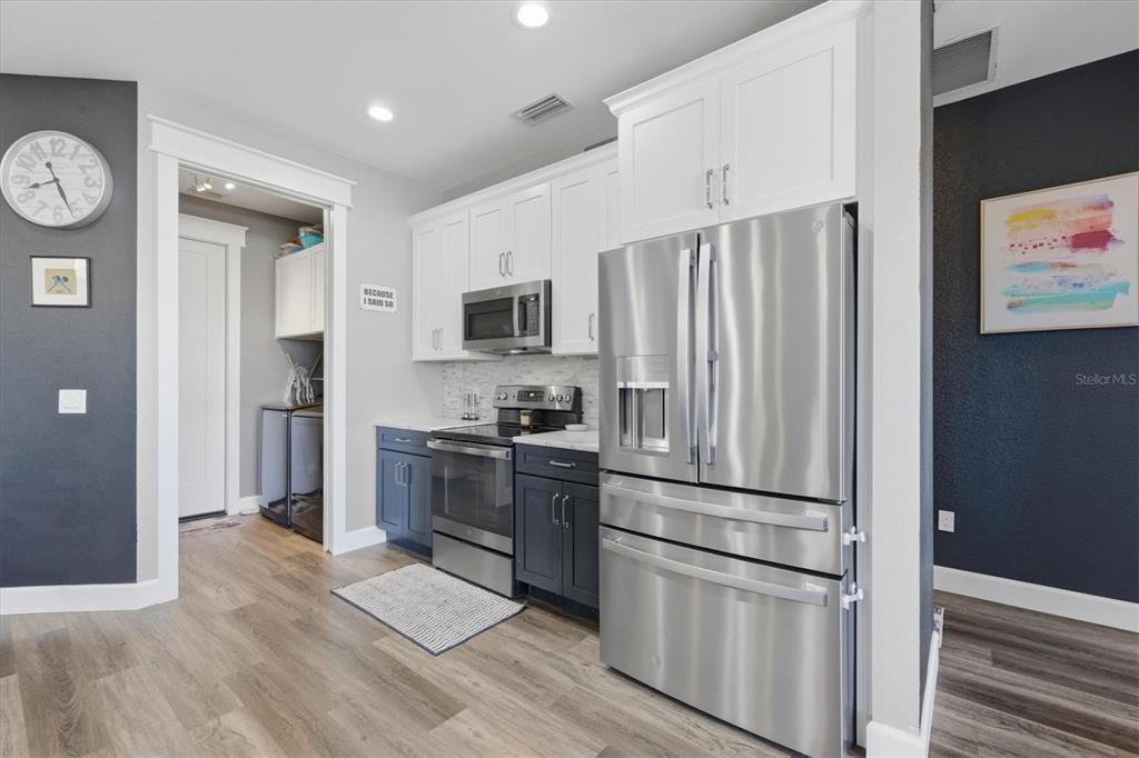 20 Brig Circle East Placida, FL 33946 - Photo 12 of 44 a kitchen with kitchen island wooden floor appliances and cabinets