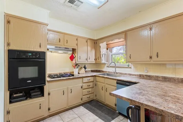 a kitchen with a sink stove and cabinets