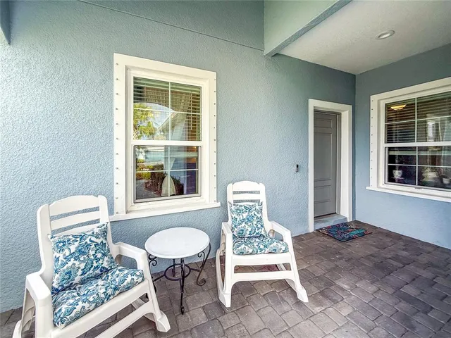 a front view of a house with outdoor seating
