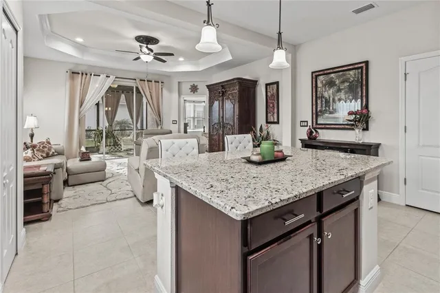 a living room with granite countertop furniture and a chandelier