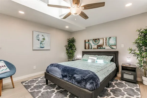 a bedroom with a large bed and a chandelier