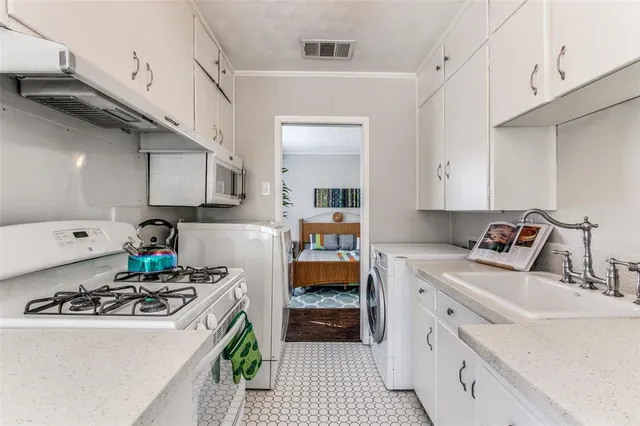 a kitchen that has a sink and a stove
