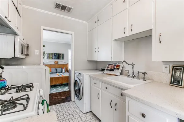 a kitchen that has a sink and a stove