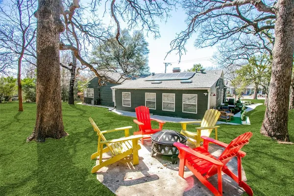 a view of a house with backyard porch and sitting area