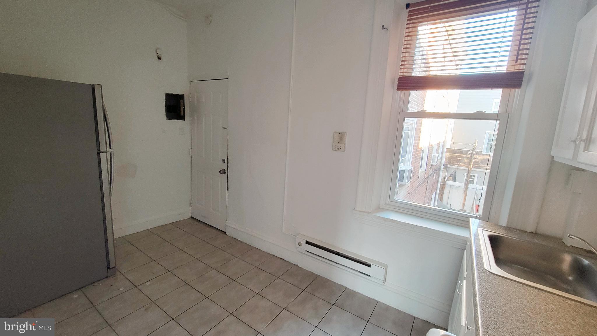 1249 Shackamaxon Street, Unit 2F Philadelphia, PA 19125 - Photo 3 of 9 a view of an empty room with windows