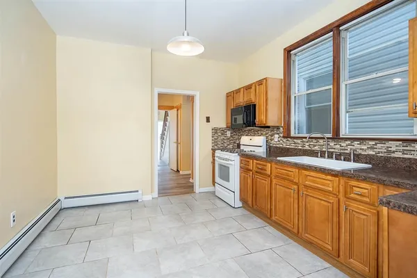 a large bathroom with a sink a mirror and a bathtub