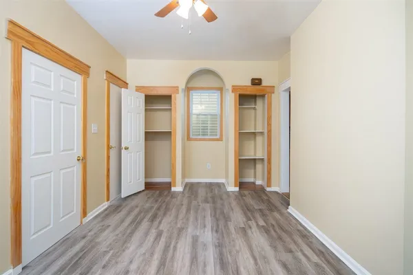 a view of a room with wooden floor