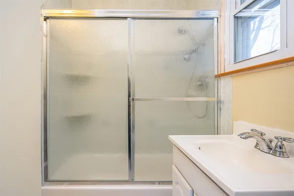 a bathroom with a shower and a sink