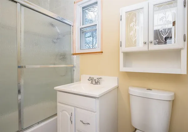 a bathroom with a sink a toilet and a shower