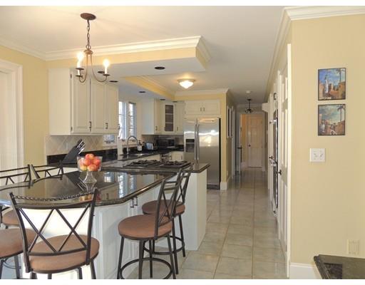 13 Snow Fields Road Mattapoisett, MA 02739 - Photo 5 of 24 a kitchen with stainless steel appliances kitchen island granite countertop a dining table chairs and white cabinets
