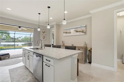 a view of a kitchen with a sink and wooden floor