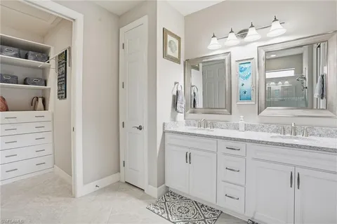 a bathroom with a granite countertop sink mirror and