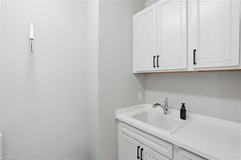 a bathroom with a sink and cabinets